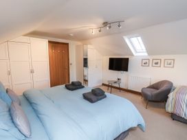 A bedroom with a bed and television at Chestnut Barn in Aislaby near Whitby