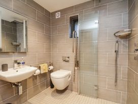 A bathroom with a sink, toilet, and shower at Chestnut Barn Aislaby near Whitby