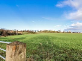 A field with a fence and distant trees at Chestnut Barn Aislaby near Whitby