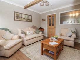 A living room with sofas and a coffee table at Daffodil Cottage in York