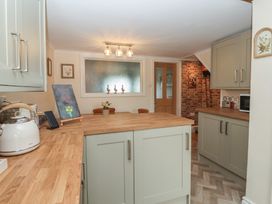 A kitchen with cabinets and a counter at Daffodil Cottage in York