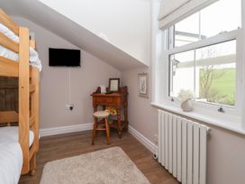 A bedroom with a bunk bed and a side table at Daffodil Cottage in York