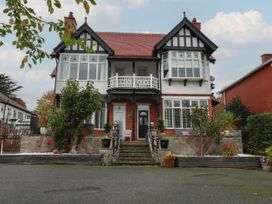 An outdoor view of a house with a balcony at The Magnolia in Rhos-On-Sea