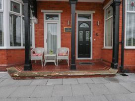 A porch with chairs and a table at The Magnolia in Rhos-On-Sea