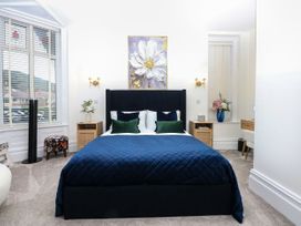 A bedroom with a bed and bedside table at The Magnolia in Rhos-On-Sea