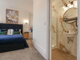 A bedroom with a bed and an attached bathroom at The Magnolia in Rhos-On-Sea