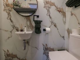 A bathroom with a sink and toilet at The Magnolia in Rhos-On-Sea