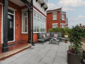 An outdoor seating area with a sofa and table at The Magnolia in Rhos-On-Sea