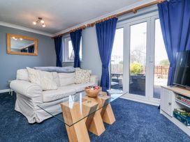 A living room with a sofa and a coffee table at Sea Spray in Westward Ho!