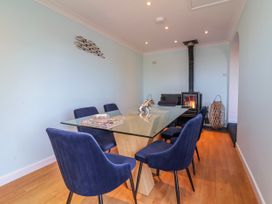 A dining room with a glass table and chairs at Sea Spray, Westward Ho!