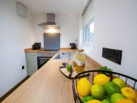 A kitchen with a sink and countertop at Fir Cottages in Llanrwst