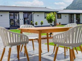 A table and chairs on a patio at Silver Birch Cottage in Llanrwst
