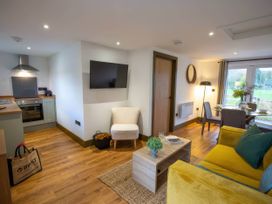 A living room with a sofa and coffee table at Silver Birch Cottage in Llanrwst