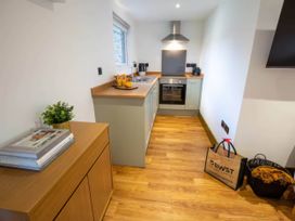 A kitchen with cabinetry and appliances at Silver Birch Cottage Llanrwst