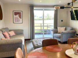 A living room with a sofa and an armchair at River View Cottage in Llanrwst