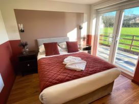 A bedroom with a bed and bedside table at River View Cottage Llanrwst