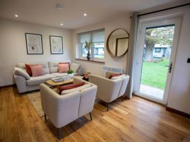 A living room with a sofa and armchairs at Mountain View Cottage in Llanrwst
