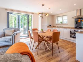 A dining room with a table and chairs at Mountain View Cottage in Llanrwst