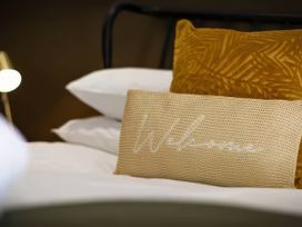 A bed with pillows in a bedroom at Mountain View Cottage in Llanrwst