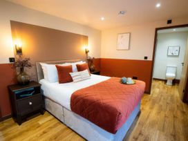A bedroom with a bed and nightstand at Mountain View Cottage in Llanrwst