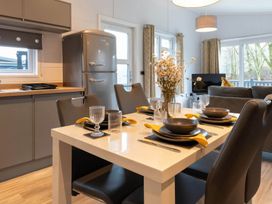 A dining room with a table set for meals at The Falls in Leyburn