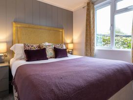 A bedroom with a bed and bedside lamps at The Falls in Leyburn