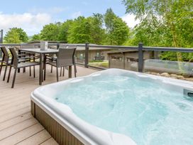 A hot tub with a table and chairs on a deck at Wensleydale (Pet) Aysgarth