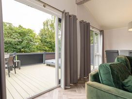 A living room with a balcony and outdoor furniture at Wensleydale (Pet) Aysgarth