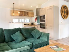 A kitchen with a green sofa and appliances at Wensleydale (Pet) Aysgarth