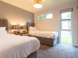 A bedroom with two beds and a window at Wensleydale (Pet) Aysgarth