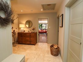 A hallway with a console table and a mirror at Fairview in Darsham