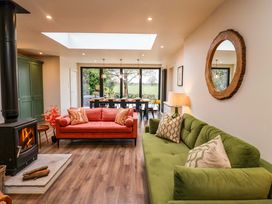A living room with sofas and a dining area at Fairview in Darsham
