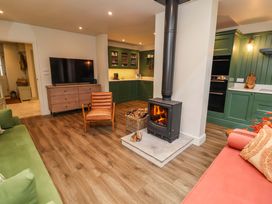 A living room with a fireplace and television at Fairview in Darsham