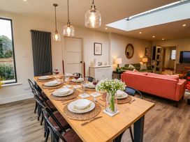 A dining room with a table set for dinner at Fairview in Darsham