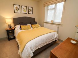 A bedroom with a bed and lamp at Fairview in Darsham