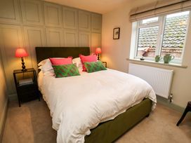 A bedroom with a bed and bedside tables at Fairview in Darsham