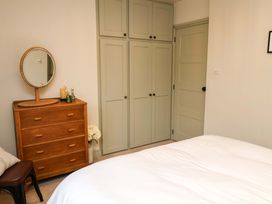 A bedroom with a dresser and mirror at Fairview in Darsham