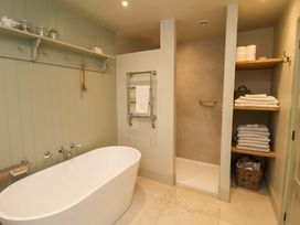 A bathroom with a bathtub and shower area at Fairview in Darsham