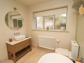 A bathroom with bathtub, sink, toilet, and radiator at Fairview in Darsham