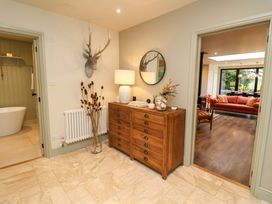 A hallway with a buffet table and a mirror at Fairview in Darsham