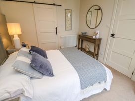 A bedroom with a bed and decorative items at Fairview in Darsham