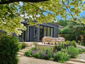 A house with outdoor seating and plants in the garden at Fairview in Darsham