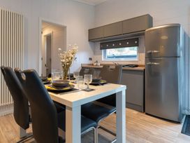 A kitchen with a table and chairs at The Falls (Pet) Leyburn