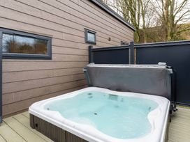 A hot tub on a deck in an outdoor area at The Falls (Pet) Leyburn