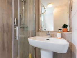 A bathroom with a shower and sink at The Falls (Pet) in Leyburn