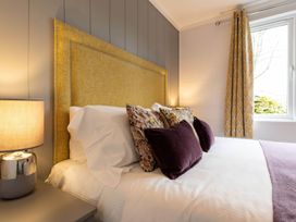 A bedroom with a bed and bedside lamp at The Falls (Pet) Leyburn