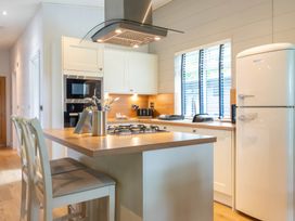 A kitchen with appliances and seating at Bainbridge in Leyburn