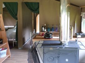 An indoor kitchen with stove and table at Aeron in Newcastle Emlyn