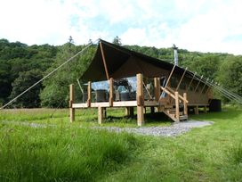 A tent structure with wooden deck and steps at Teifi in Newcastle Emlyn