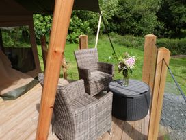 An outdoor seating area with two chairs and a table at Teifi Newcastle Emlyn